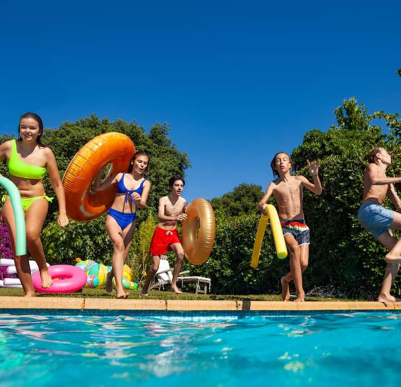 Kids jumping into swimming pool